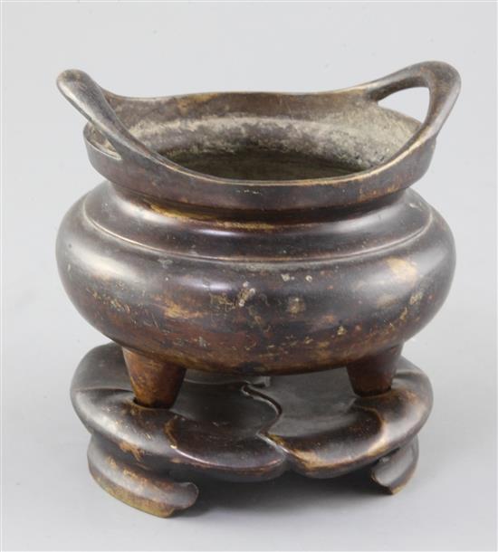 A Chinese bronze ding censer and stand, width 15.5cm